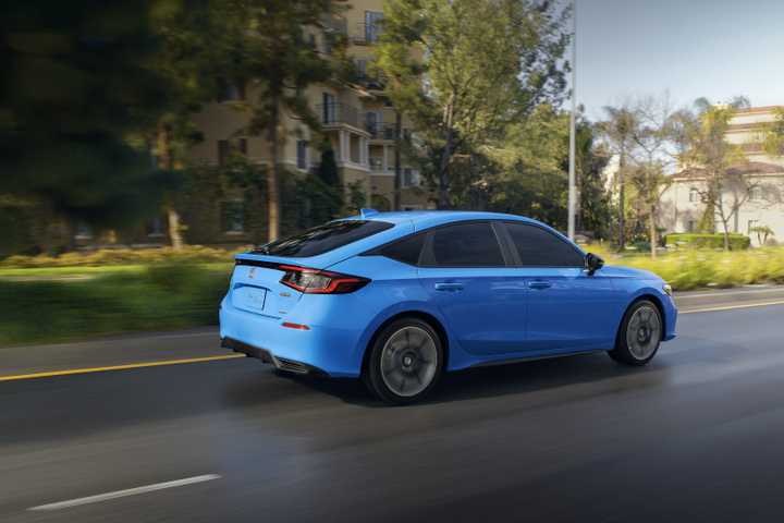 Rear 3/4 action shot of a 2025 Honda Civic