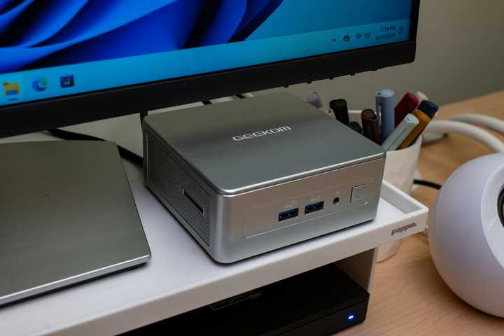 The GEEKOM AE7 mini PC on a desk.