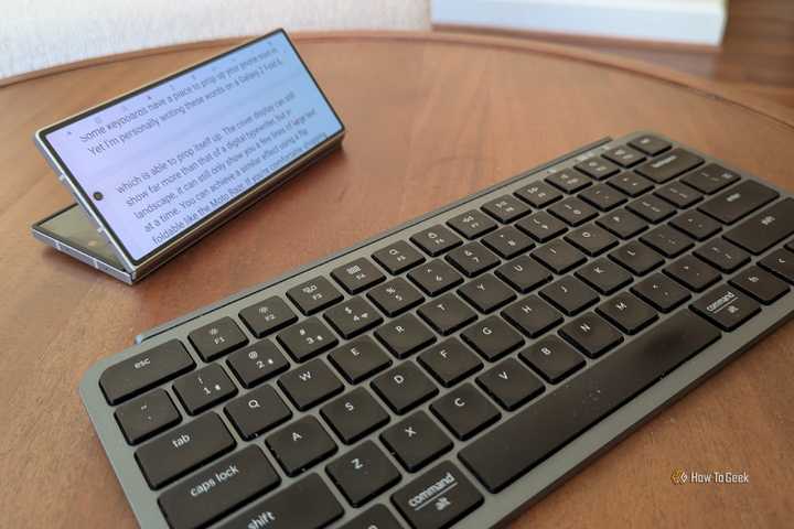 A Bluetooth keyboard issued to a Galaxy Z Fold 6 that is partially folded.