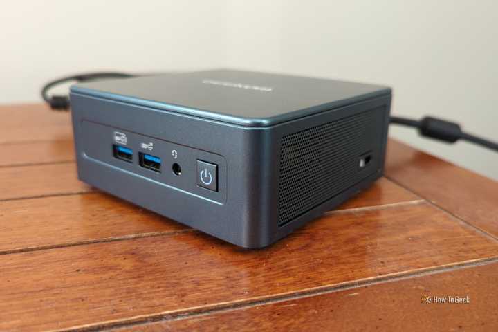 A Geekom mini PC plugged in and powered on.-1