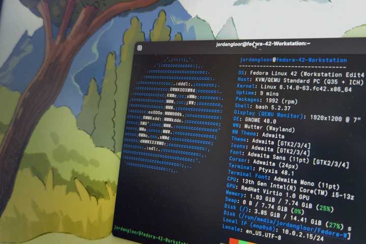 A laptop screen showing Fedora Linux 42 with a terminal open.