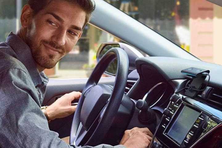 A man running errands with an echo auto in his car.