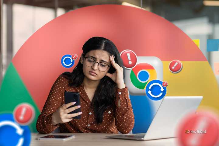 A woman at an office desk with a disappointed expression, holding her phone, with a laptop on the table and the Chrome icon with some sync and alert signs.