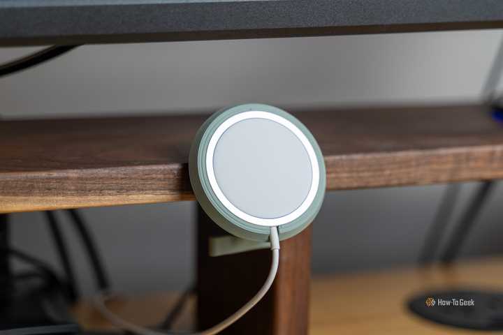 A 3D printed MagSafe charger holder mounted to a Walnut desk shelf.