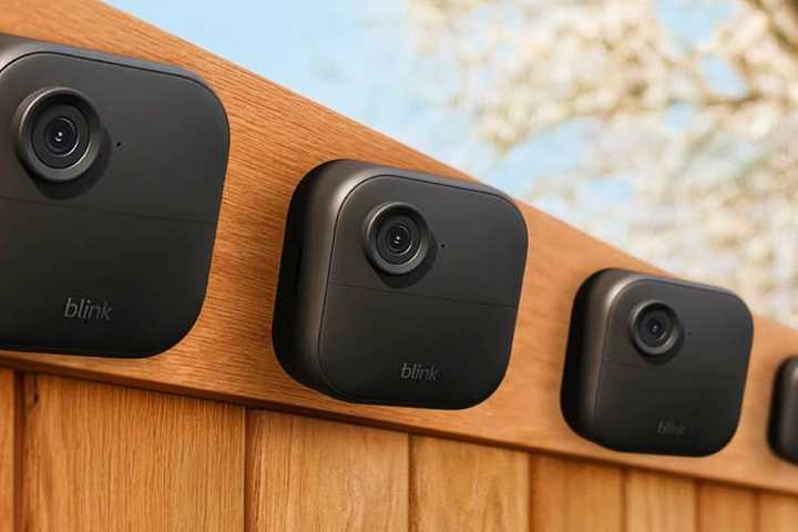 Multiple Blink Outdoor 4 cameras Photoshopped onto a fence.