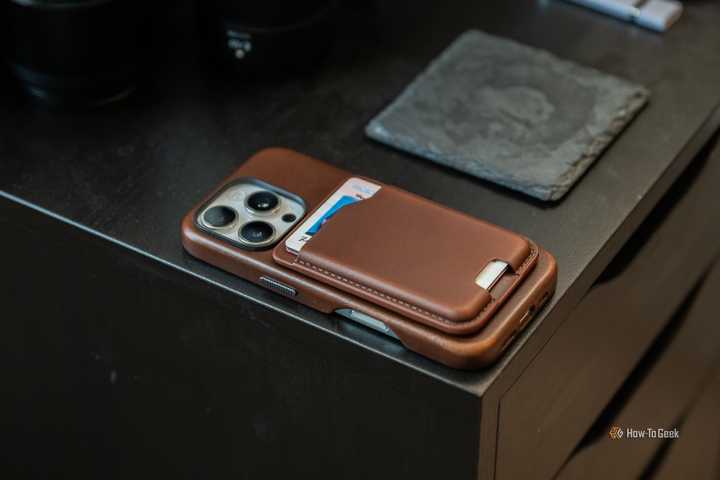 Nomad Leather Mag Wallet attached to an iPhone 16 Pro sitting on a table.