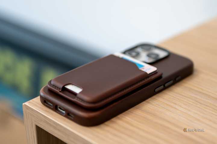 Nomad Leather Mag Wallet attached to an iPhone laying on a table.-1