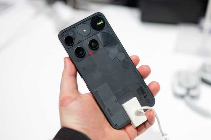 Person holding the Nothing Phone 3 showing the entire back.