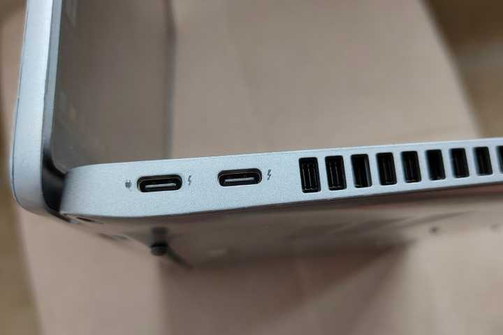 A close-up of two USB-C Thunderbolt 4 ports on a laptop.