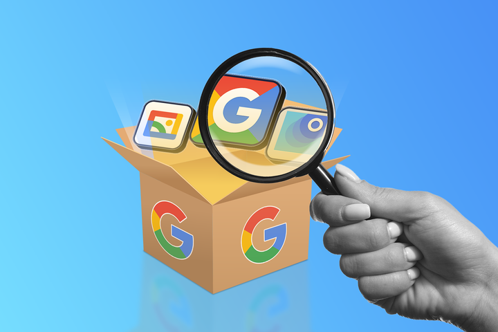 A cardboard box with the Google logo containing three Google app icons, with a hand holding a magnifying glass over them.
