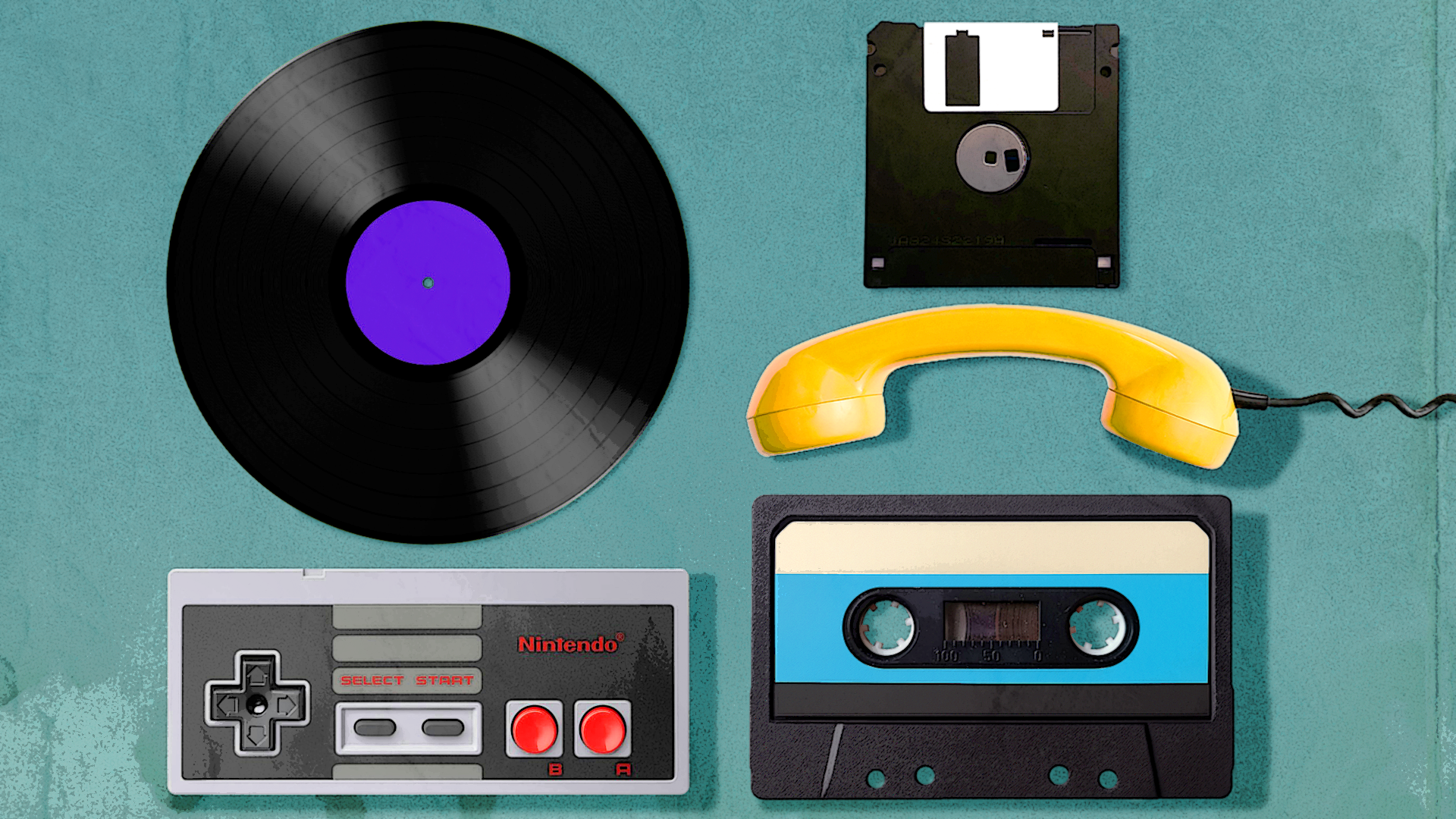 Flat lay of vintage tech items on a teal surface, including a vinyl record, floppy disk, yellow telephone handset, cassette tape, and a Nintendo controller.
